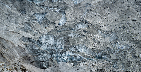 View of Khumbu glacier nearly Everest base camp in Nepal underneath moraine rocks. Moraines are formed from debris previously carried along by a glacier.