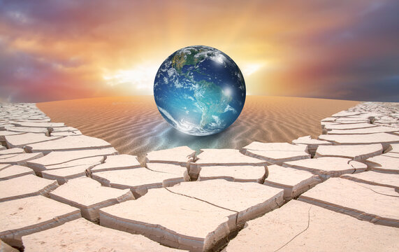 Climate change concept with earth planet on sand dune and dry soil "Elements of this image furnished by NASA"