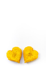 Two heart shaped fried plantain isolated on white background