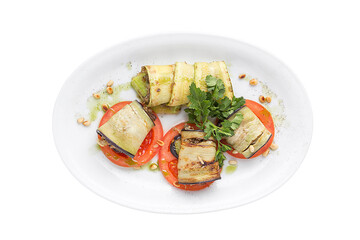 Original serving eggplants and baked tomatoes. Restaurant service concept. Isolated.