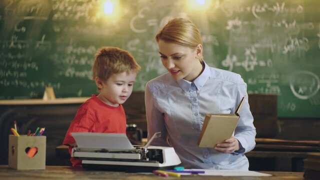 Preschool child. Mother and son typing on typewriter. Schoolboy sitting in class.