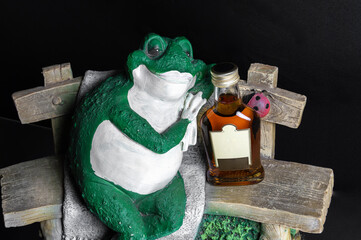 toad on a bench in a place with alcohol