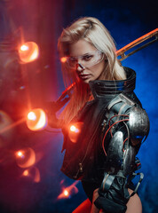 Fototapeta na wymiar Dressed in black jacket cyber woman from the future poses with her blade in dark blue background.