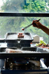 People grilling korean barbeque