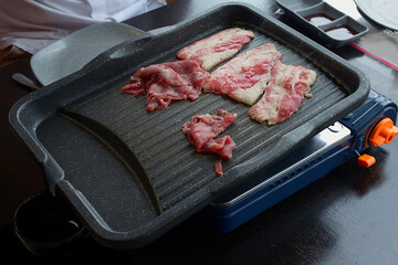 People grilling korean barbeque