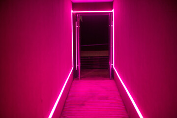 Pink neon lights inside of empty theatre