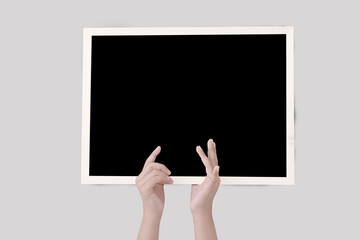 Human hand holding blackboard