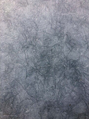 icy surface of frozen winter lake, after severe frosts, with cracks, waves, rough texture, icy air bubbles, scratches.