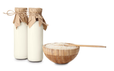 Bottles of rice milk on white background