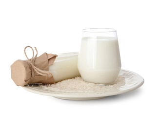 Bottle and glass of rice milk on white background