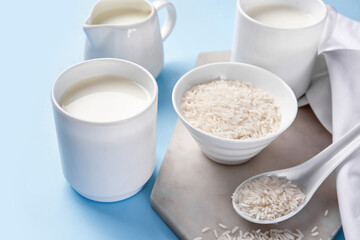 Cup of rice milk on color background