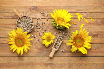 Seeds in scoop and beautiful sunflowers on wooden background