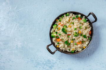 Vegan rice, stir-fried with vegetables, overhead shot with copy space