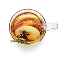 Tasty drink with spices and apple slices in cup on white background