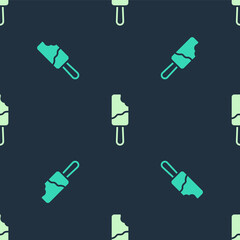 Green and beige Ice cream on stick icon isolated seamless pattern on blue background. Sweet symbol. Vector.