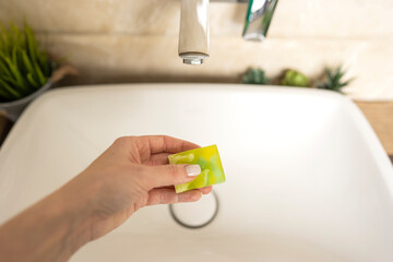 A woman wants to wash her hands with a hand made aroma soap