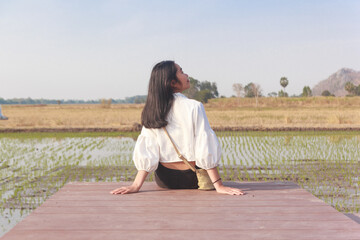 Portrait girl teen Asian white dress is sitting