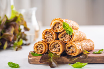 Pancake rolls stuffed with ground meat, rice and fried onion. 