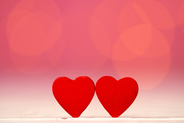 Red heart decoration against pink bokeh background