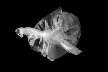 White plastic bag isolated on black. Empty crumpled plastic bag isolated on a black background....