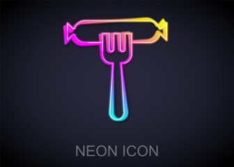 Glowing neon line Sausage on the fork icon isolated on black background. Grilled sausage and aroma sign. Vector.