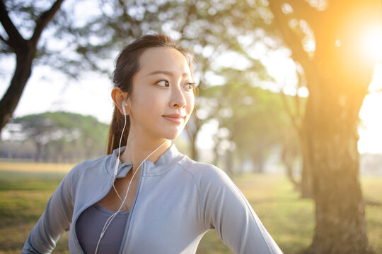 closeup beautiful young woman face before running in the park at  morning