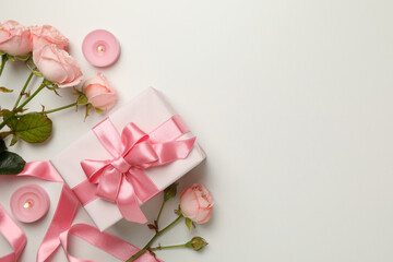 Concept of Valentine's day with roses, gift boxes and candles on white background