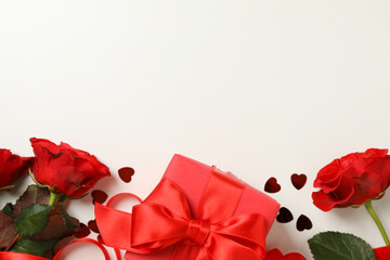 Concept of Valentine's day with roses and gift box on white background