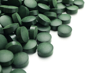 Spirulina in pills isolated on white background