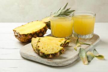Concept of breakfast with pineapple and glasses with juice on wooden table