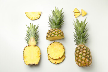 Flat lay with pineapple and slices on white background