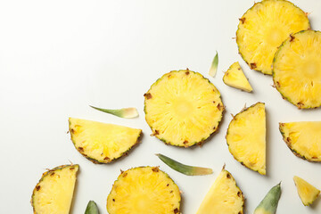 Flat lay with pineapple slices on white background, top view