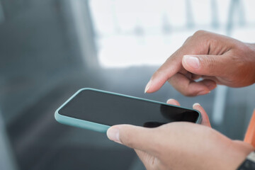 Close-up of a man's hand using a smartphone for shopping Search or social concept
