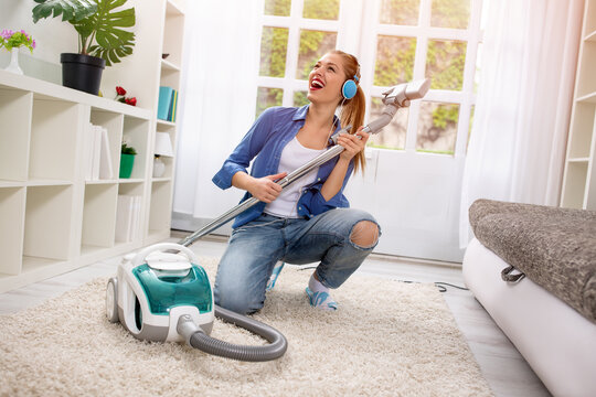 Funny girl with vacuum cleaner