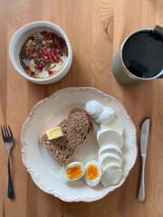 Breakfast Plate with Half Cut Boiled Eggs, Mozzarella Cheese, Butter Bread, Oatmeal Porridge Bowl with Apple slices, Chia Seeds, Honey and Walnut.