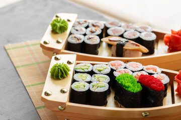 Set of maki sushi on wooden boat tray