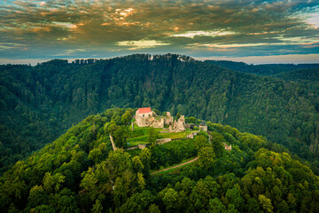 Fototapeta na wymiar The extensive ruins of Potstejn Castle lie on a wooded conical hill southeast of the village of Potstejn in Eastern Bohemia and dominate the central part of Podorlicko.
