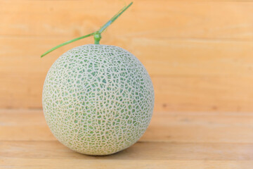 Fresh green melon on wood plate