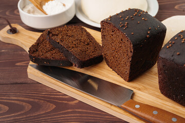 Sliced rye bread on brown wooden background