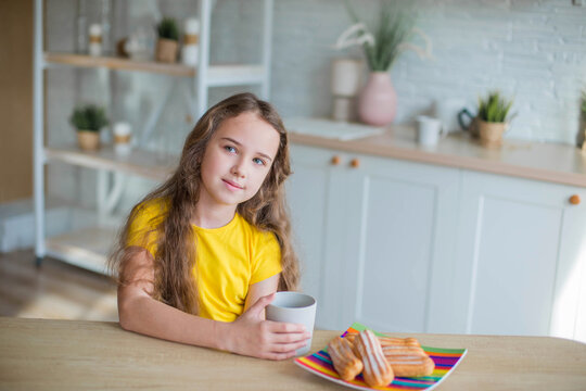 Happy Curly Girl In Yellow Shirt In The Kitchen 