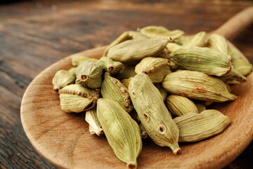 Сardamom spice bunch on wooden table macro