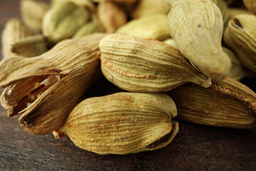 Сardamom spice bunch on wooden table macro