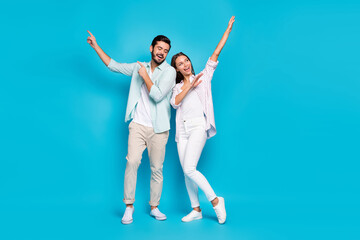 Full length photo of cheerful guy pretty lady dancing enjoying vacation isolated on blue color background