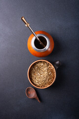 Mate - Paraguayan tea and calabash is a vessel for preparing and drinking mate. On a black...