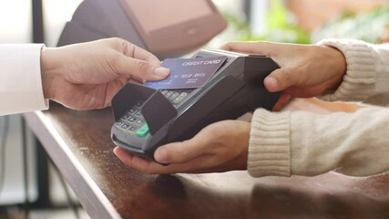 Customer using credit card for payment to owner at cafe restaurant, cashless technology and credit card payment concept - Powered by Adobe