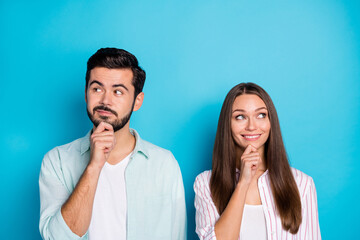 Photo of minded married couple hand chin look empty space think happy life isolated on blue color...