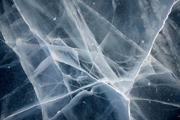 texture of cracks in the clear ice of a frozen lake