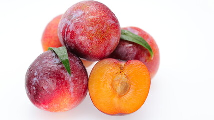 Closeup of fresh ripe plums isolated on white background, healthy organic fruit
