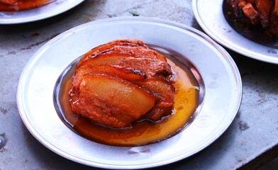 Chinese cuisine, top view of steamed pork belly in plate