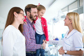 Family visits dentist in dental office